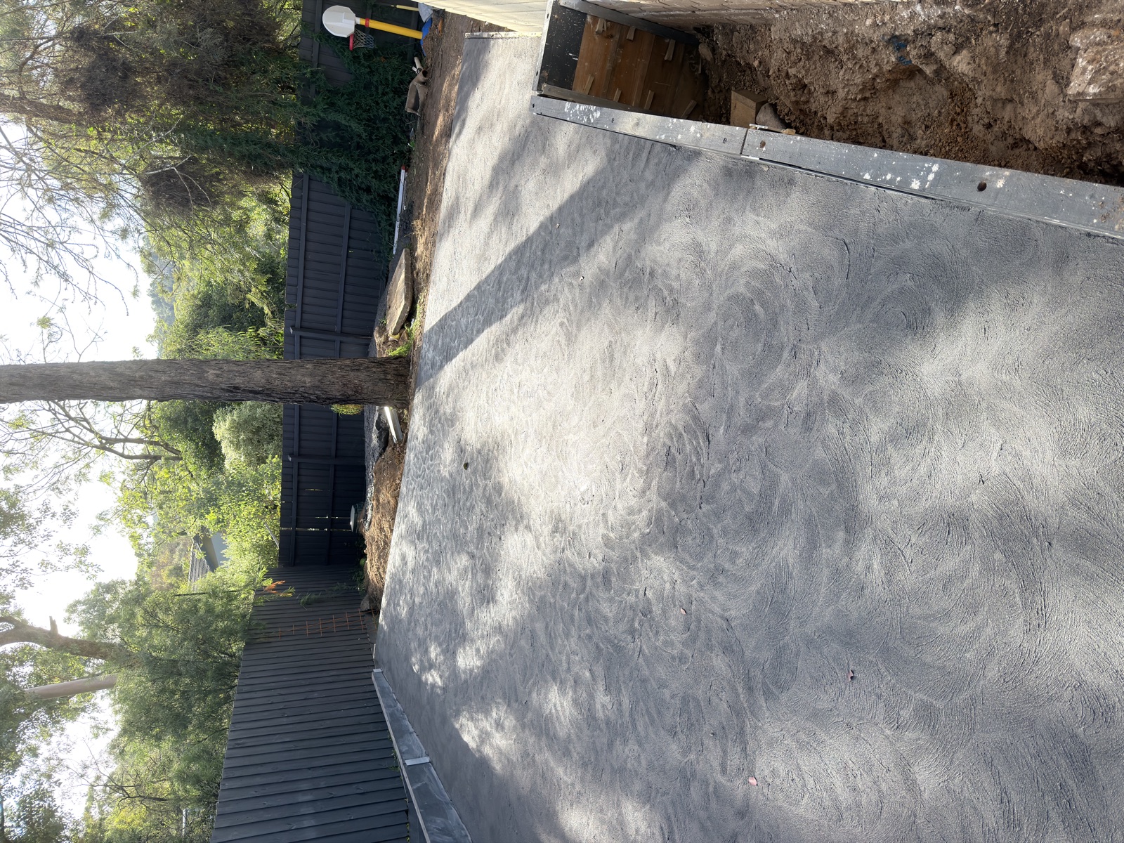 Freshly poured concrete base for a basketball court in Eltham